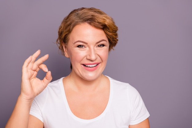 Portrait of lady in white t-shirt isolated on purple