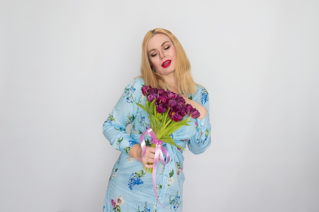 Portrait of lady with purple flowers in studio