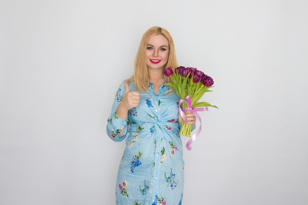 Portrait of lady with purple flowers in studio