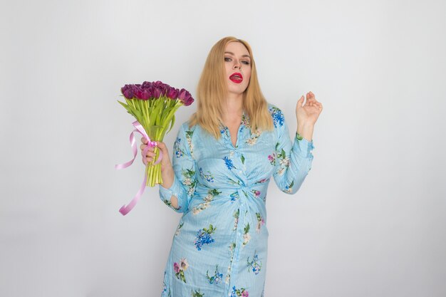 Portrait of lady with purple flowers in studio