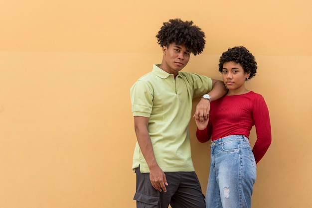 Photo portrait of a latin couple in front of wall stock photo