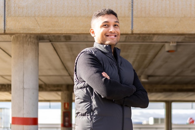 Portrait of latin entrepreneur in formal suit with crossed arms outdoors Young man in formal wear arms crossed outdoors