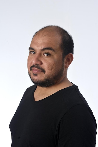 Portrait of a latin man serious and looking at camera on white background