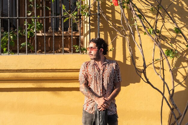 Portrait of Latin street artist holding his guitar