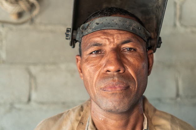 Portrait Of Latin Welder Working At Workshop