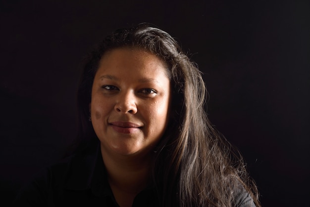 Portrait of a latin woman on black background