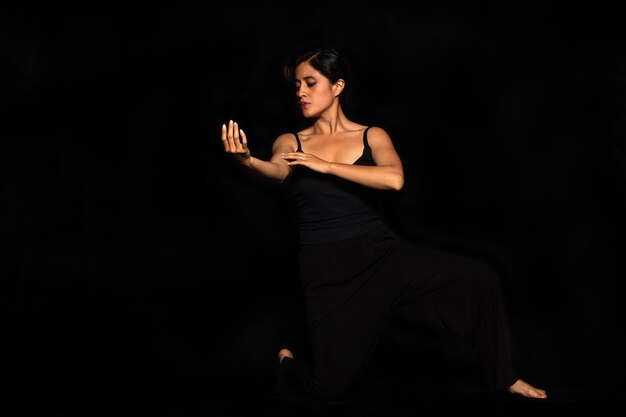 Portrait of a Latin woman posing isolated on black background Female body expression concept