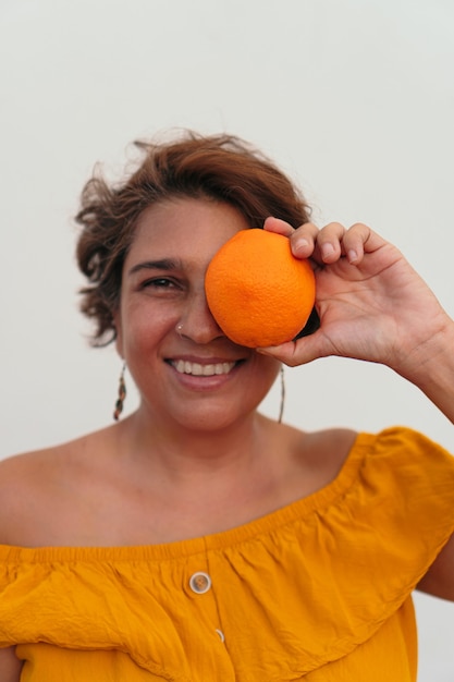 Portrait of a Latin woman with an orange