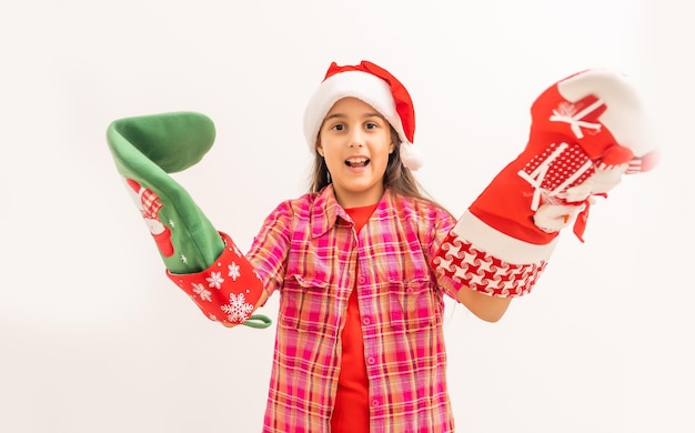 Portrait of a laughing little girl holding Christmas decoration in hands on white background