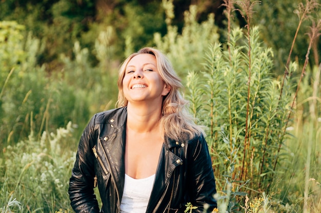 Portrait of a laughing woman in a black leather jacket. Happy woman