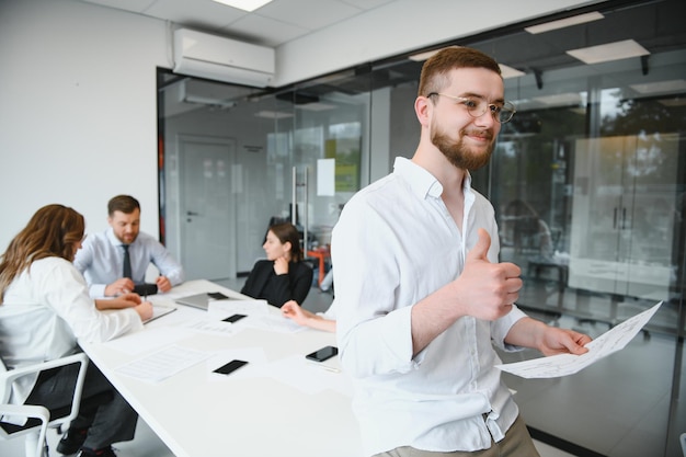 Portrait of a leader with business team behind