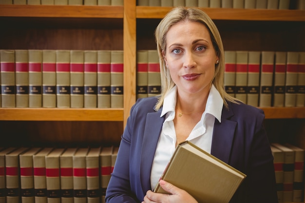 Portrait of a librarian posing and holding a book