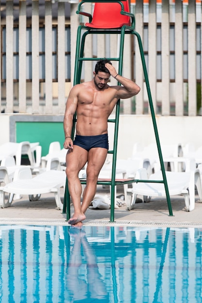 Portrait Of A Lifeguard Man At Swimming Pool