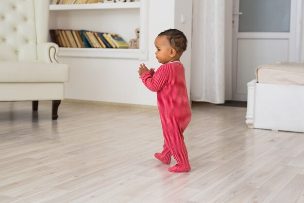 Portrait of a little african american baby boy playing indoor.