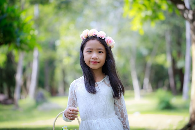 Portrait of little Asian girl smiling in  the nature forest with soft tone processed