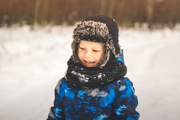 Portrait of a little boy in a hat in winter in the park