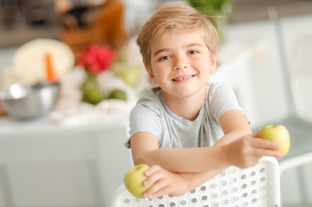Portrait of a little boy holding apples