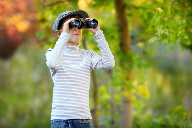 Portrait of a little boy looking through the binoculars