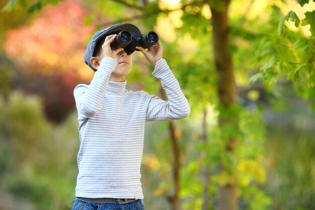 Portrait of a little boy looking through the binoculars