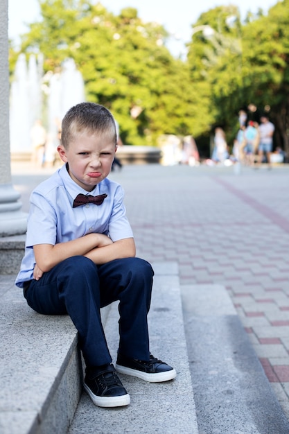 portrait little boy sitting on stairs