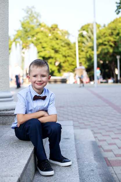 portrait little boy sitting on stairs