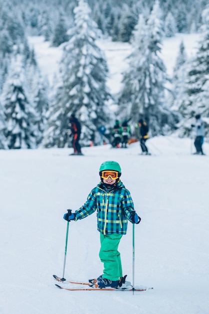 Portrait of little boy skiing