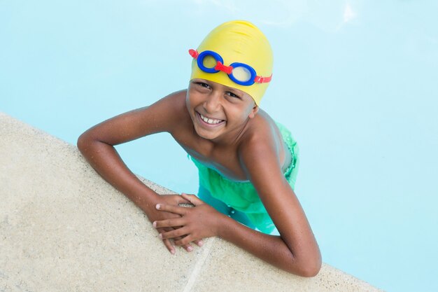 Portrait of little boy smiling in the pool