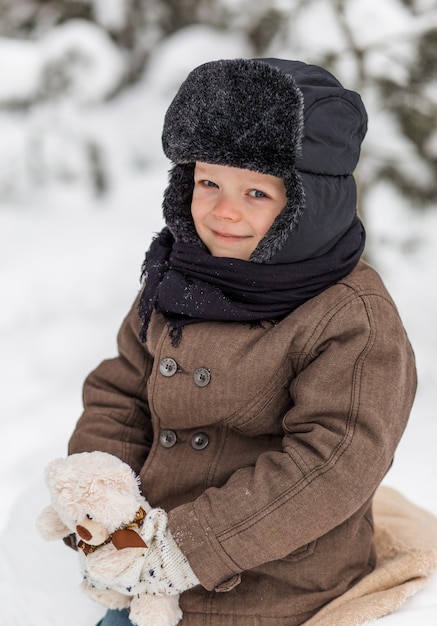 portrait of a little boy in a winter forest