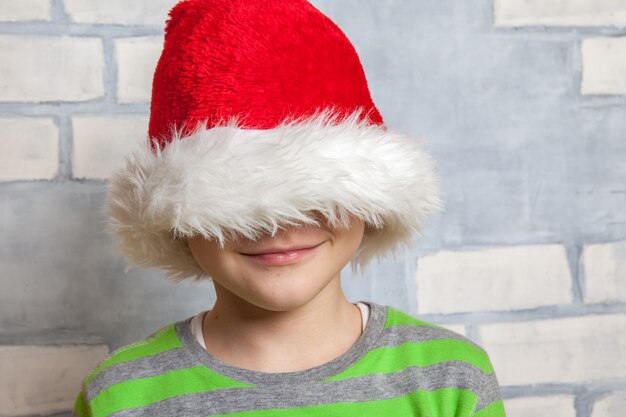 Portrait of little boy with Santa hat