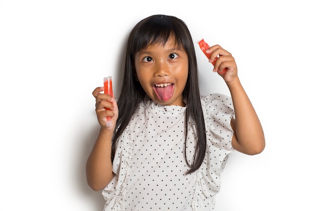 Portrait of a little cheerful Asian girl with ice cream