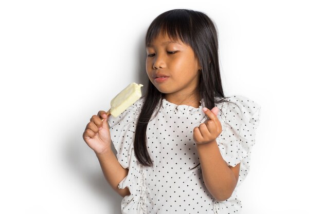 Portrait of a little cheerful Asian girl with ice cream