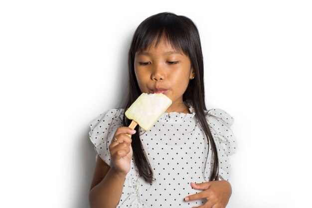 Portrait of a little cheerful Asian girl with ice cream