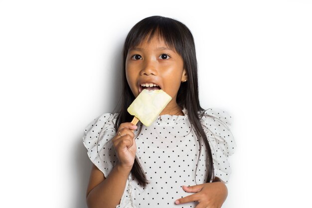 Portrait of a little cheerful Asian girl with ice cream