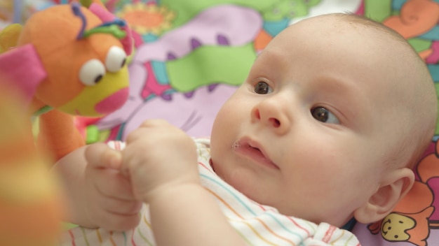 Portrait of little child looking toys Close up of cute infant boy Kid face