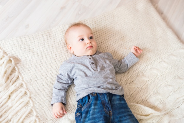 Portrait of little cute baby boy lying