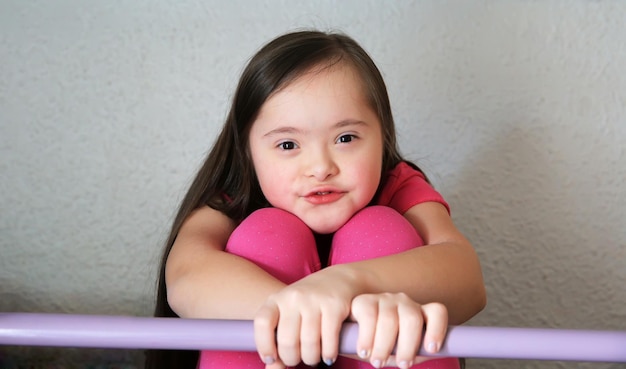 Portrait of little girl on the background of the grey wall