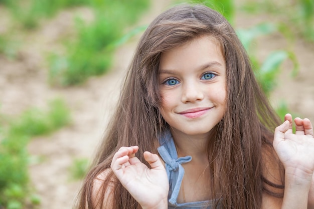 Photo portrait of a little girl before school age summer park outdoors