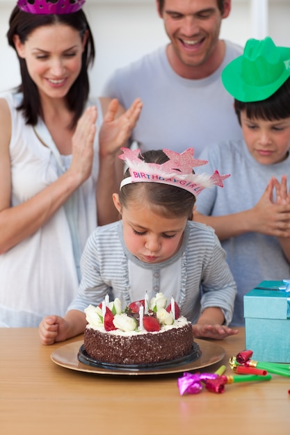 Portrait of a little girl blow out candles 