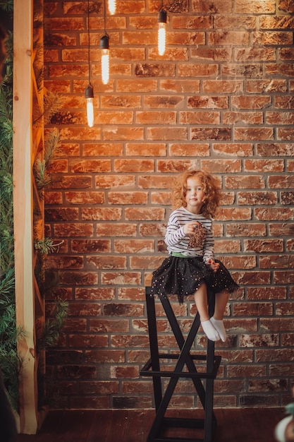 Portrait of a little girl on a brick wall background