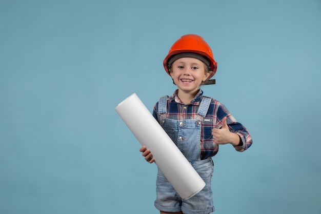 portrait of little girl builder in hardhats holding construction drawing