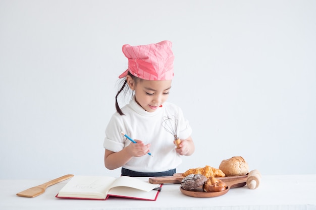 Portrait of a little girl cooking