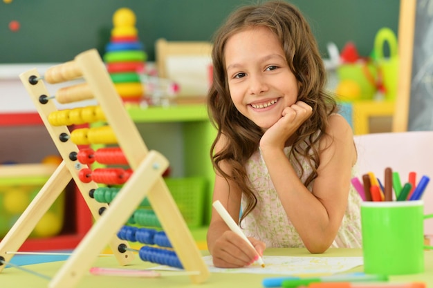 Portrait of a little girl counting on abacus