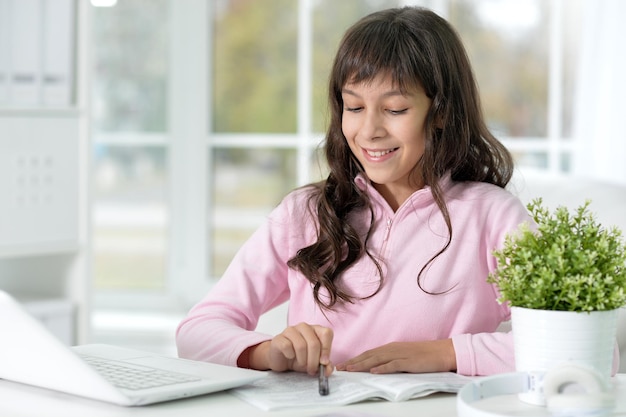 Portrait of a little girl doing lessons at home