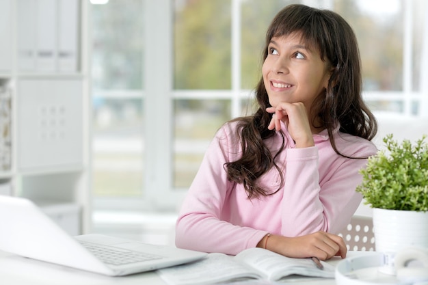 Portrait of a little girl doing lessons at home