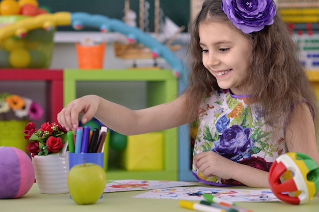 Portrait of Little girl drawing at class