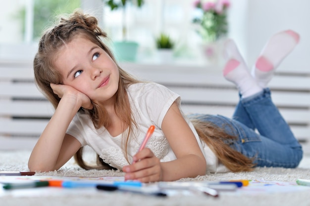 Portrait of Little girl drawing at home