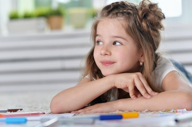 Portrait of Little girl drawing at home