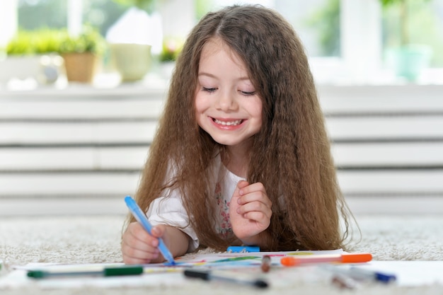 Portrait of Little girl drawing at home