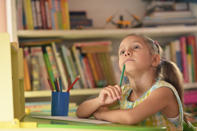 Portrait of Little girl drawing at home