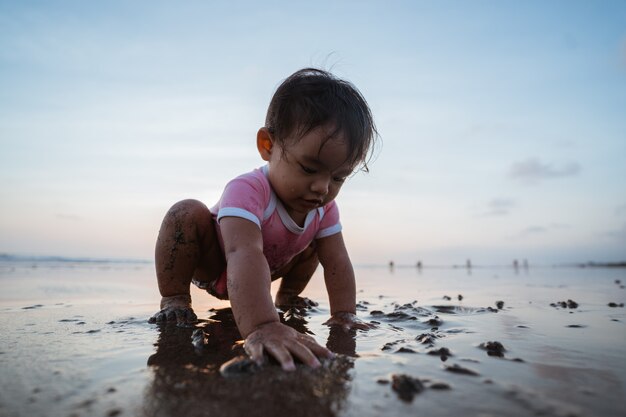 Portrait of a little girl enjoying playing a vacation on the beach